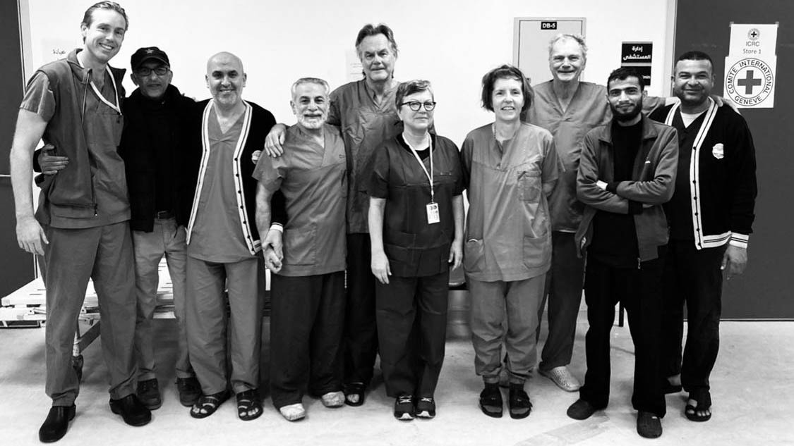 Director of MIST with local and overseas healthcare professionals standing in a room in European Gaza Hospital 2024