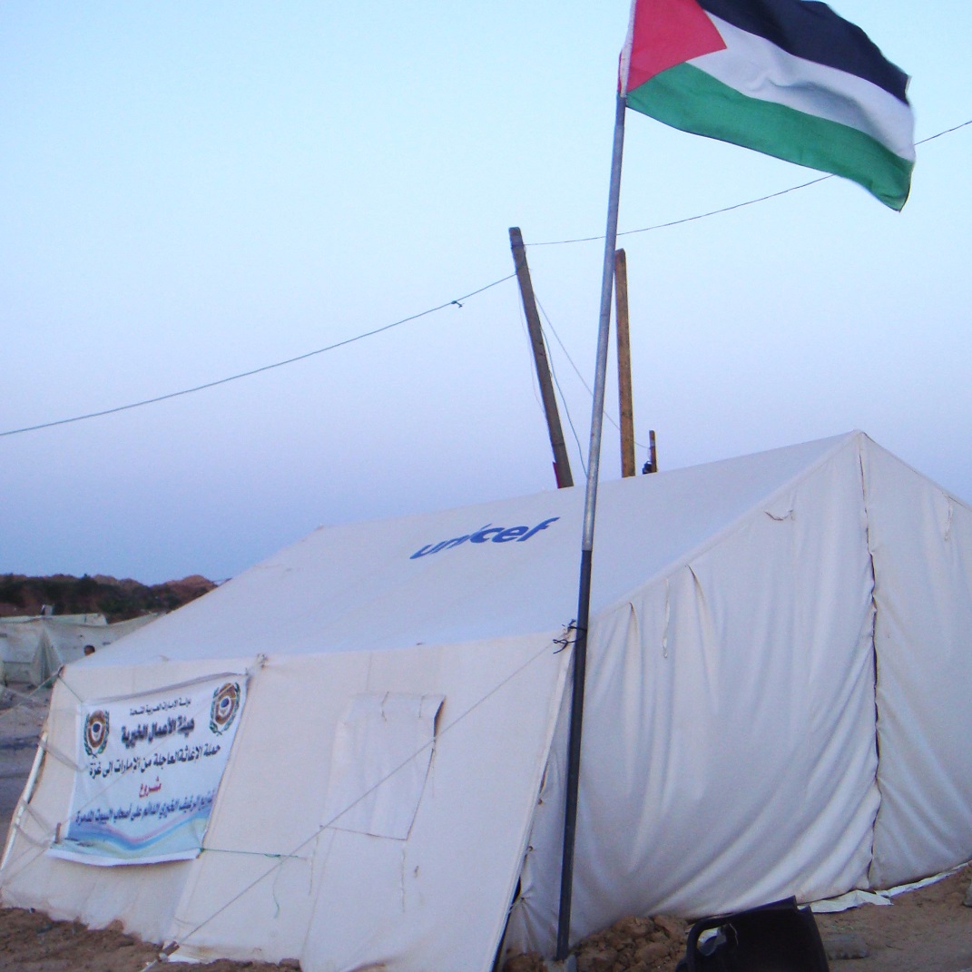 Aid tent with UNICEF logo and palestine flag